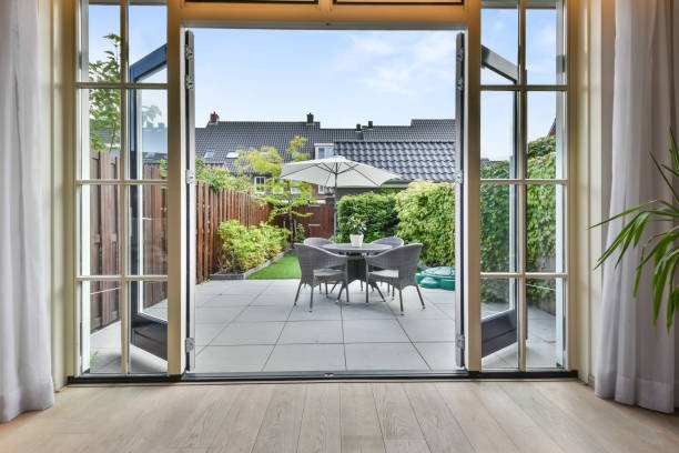 Exit to the backyard in a cozy house with a small sitting area and a garden